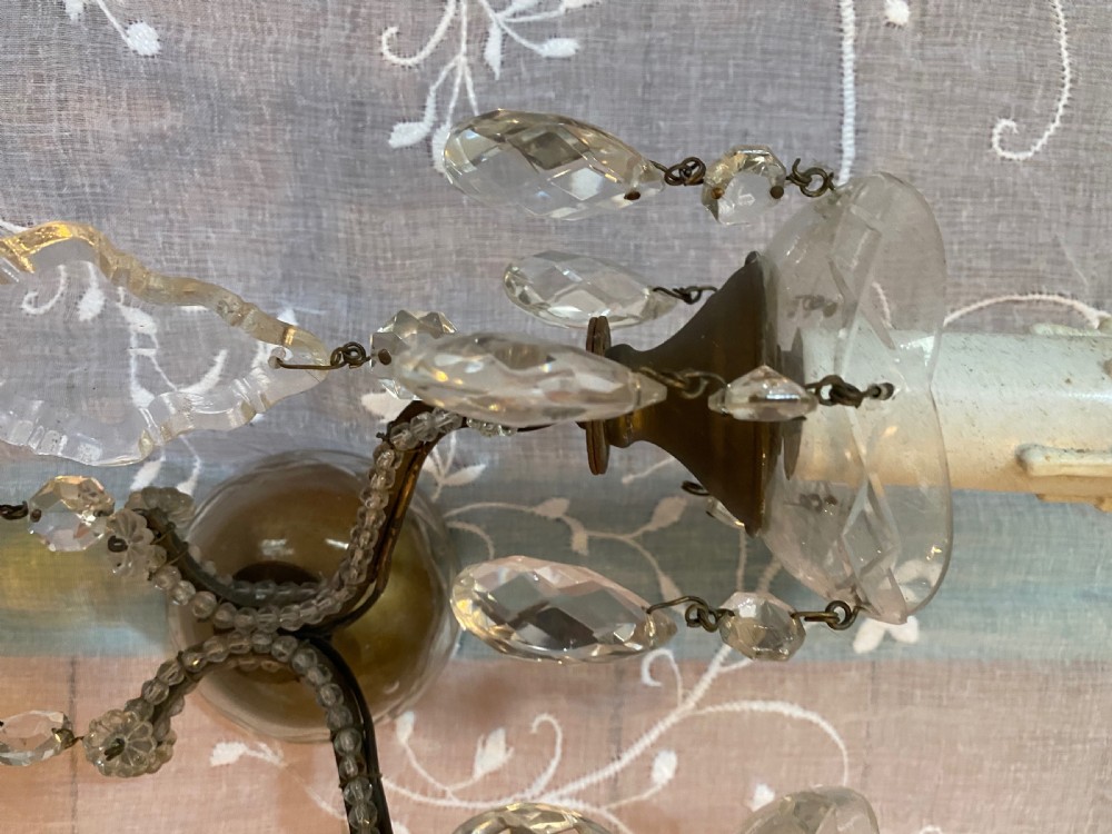 A pair of antique Florentine wall lights featuring twin curved metal arms wrapped in small glass beads, decorated with clear glass droplets, amber crystal prisms, and candle-style lamp holders. View III