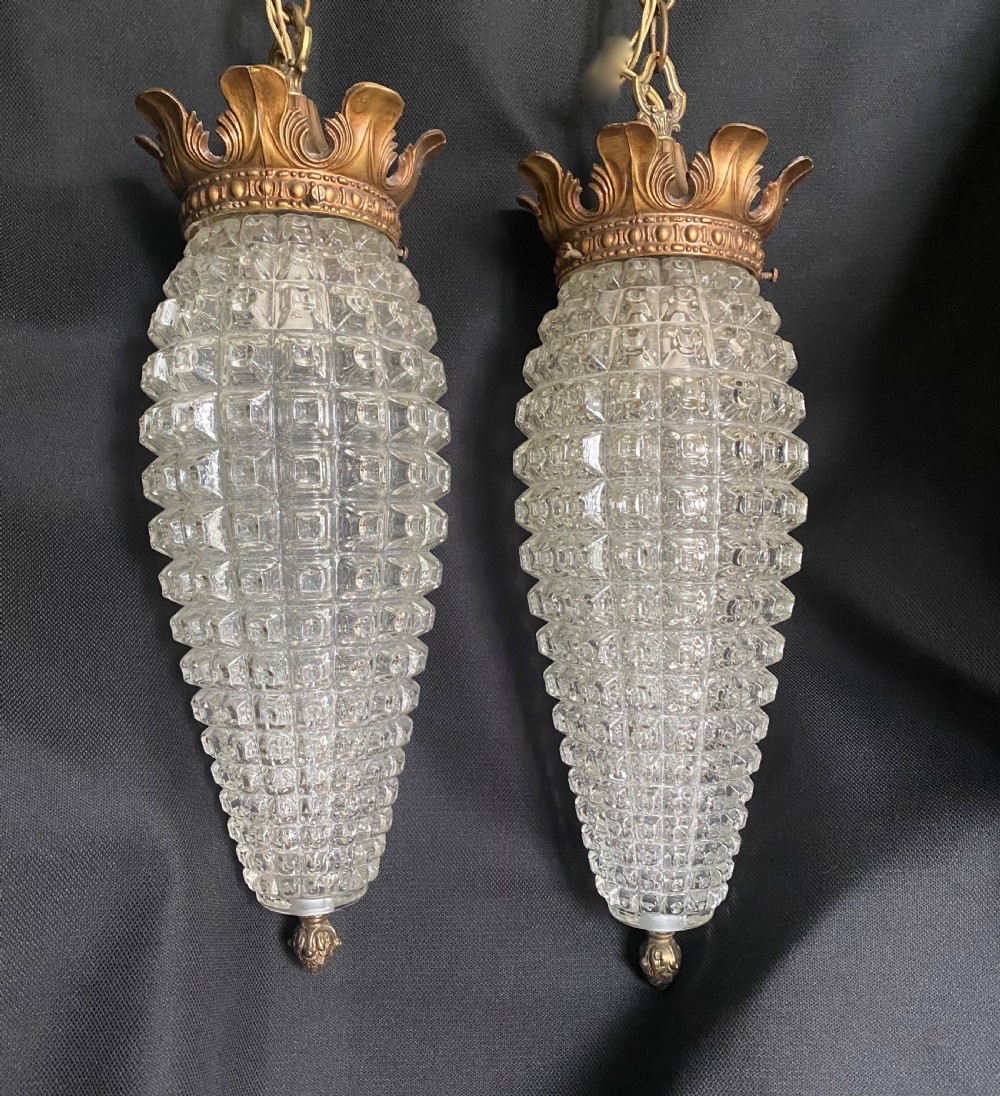 A pair of antique French cut glass hall lanterns featuring pineapple-shaped faceted glass shades topped with decorative brass crowns and hanging chains. View II