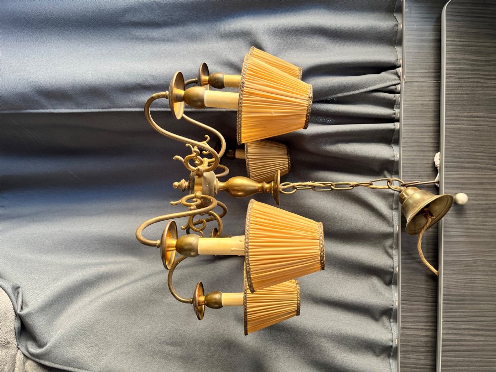 A six-arm brass Dutch pendant chandelier featuring a turned central baluster stem, scrolled arms, drip pans, and candle sleeves. View VI