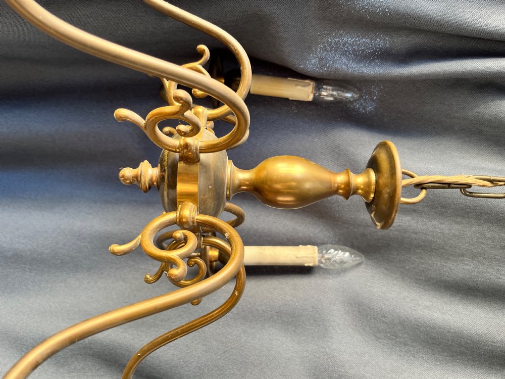 A six-arm brass Dutch pendant chandelier featuring a turned central baluster stem, scrolled arms, drip pans, and candle sleeves. View VIII