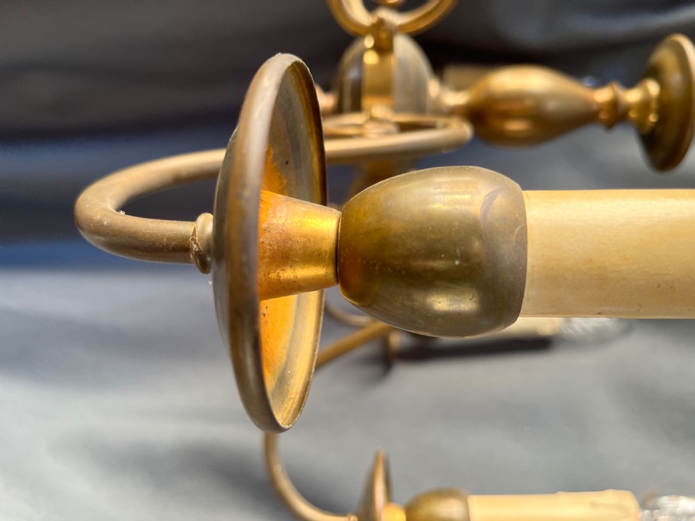 A six-arm brass Dutch pendant chandelier featuring a turned central baluster stem, scrolled arms, drip pans, and candle sleeves. View XIII