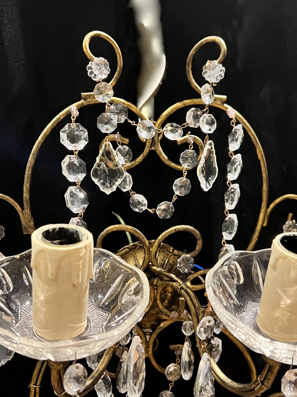 An Italian gilt metal four-light wall sconce adorned with cut crystal glass swags, drops, and faceted pendants. View II