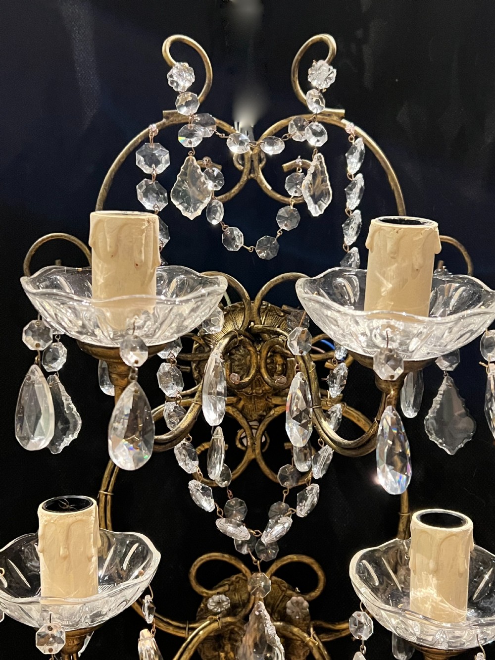 An Italian gilt metal four-light wall sconce adorned with cut crystal glass swags, drops, and faceted pendants. View III