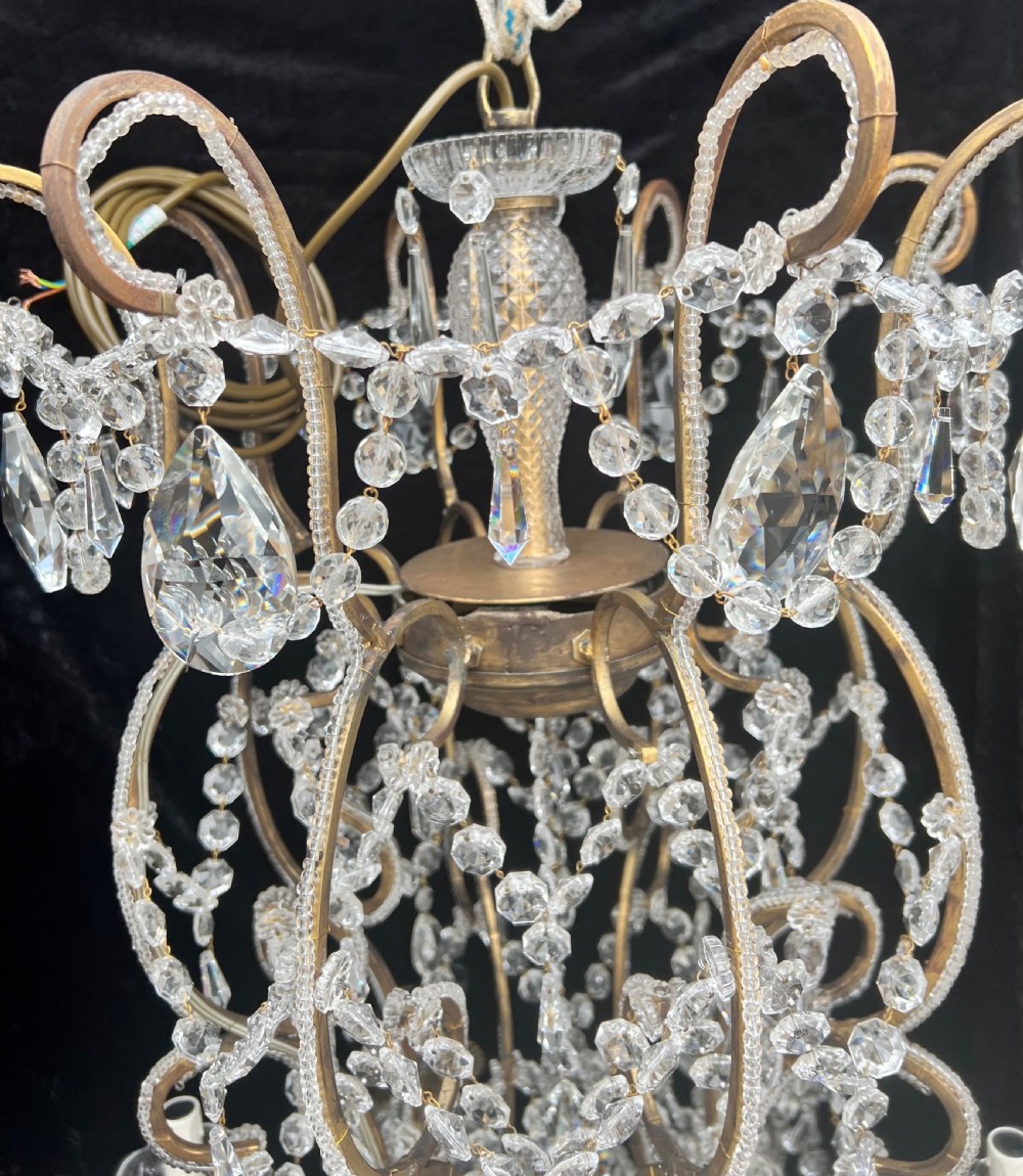 A multi-tiered Florentine chandelier crafted with a gilded metal frame, featuring 24 candle-style lights, draped crystal bead chains, and faceted glass droplets. View II