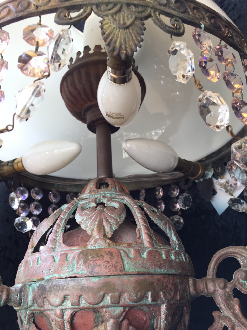 An antique French Art Nouveau pendant light featuring a white glass dome shade supported by an ornate verdigris-patinated bronze frame with suspended crystal beads. View II