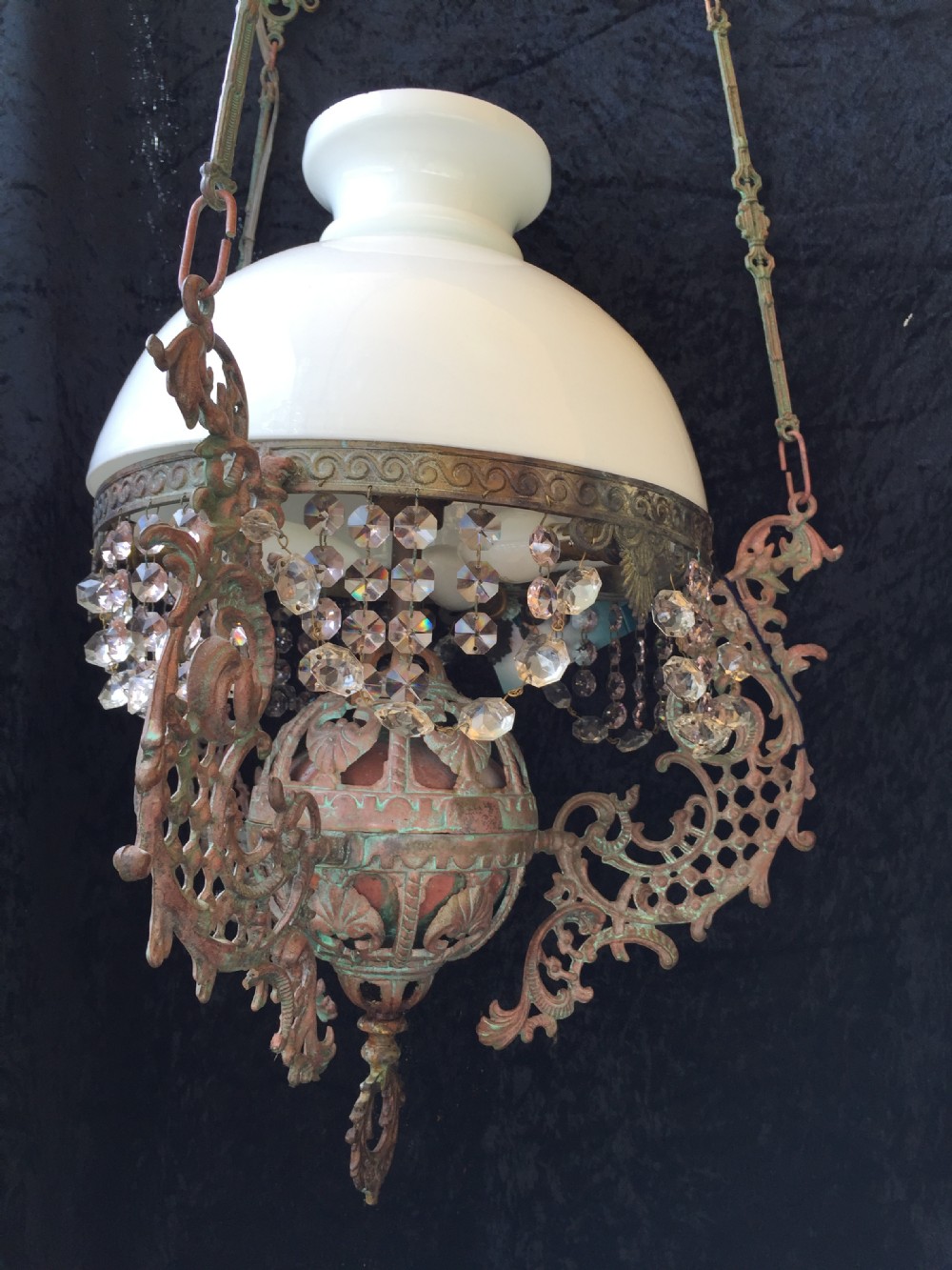 An antique French Art Nouveau pendant light featuring a white glass dome shade supported by an ornate verdigris-patinated bronze frame with suspended crystal beads. View III