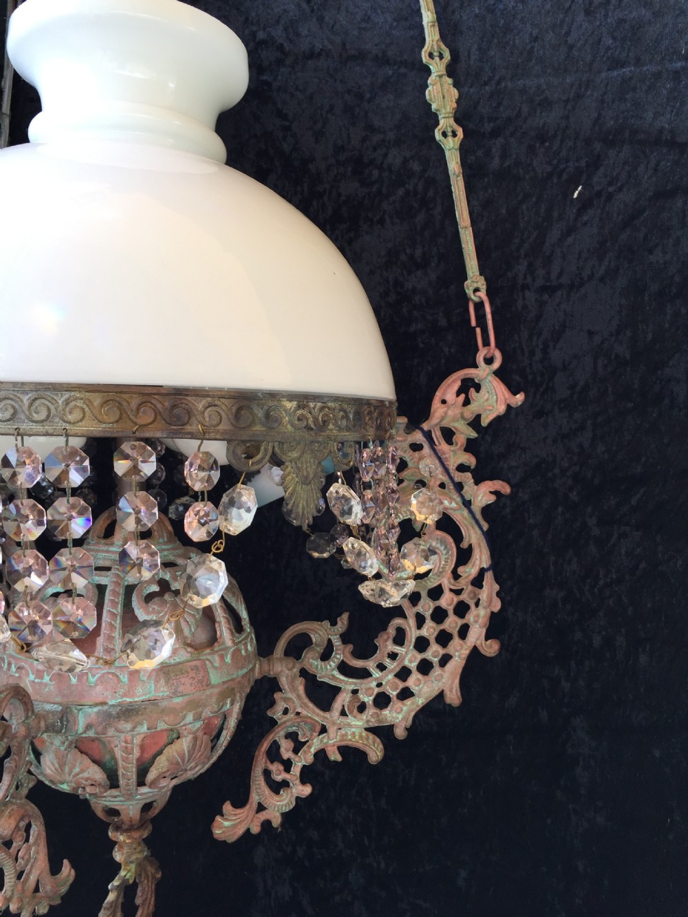 An antique French Art Nouveau pendant light featuring a white glass dome shade supported by an ornate verdigris-patinated bronze frame with suspended crystal beads. View IV