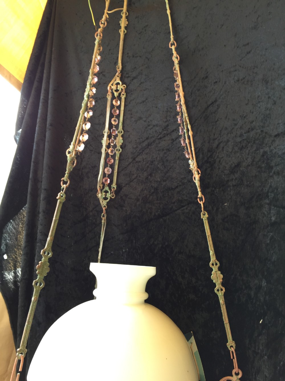 An antique French Art Nouveau pendant light featuring a white glass dome shade supported by an ornate verdigris-patinated bronze frame with suspended crystal beads. View V