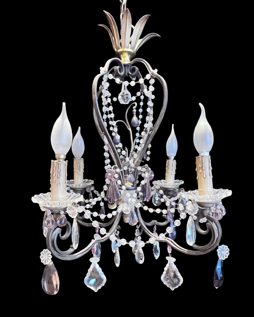 A four-arm French antique chandelier featuring a dark metal cage frame adorned with clear and amethyst-tinted glass crystal beads and teardrop pendants.