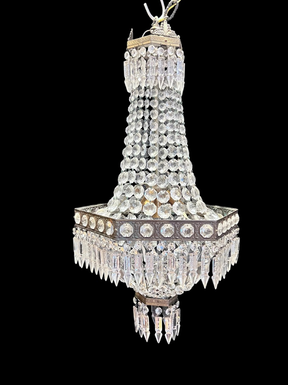 An antique French basket chandelier featuring beaded crystal strands draped over a brass frame with hanging prism drops.