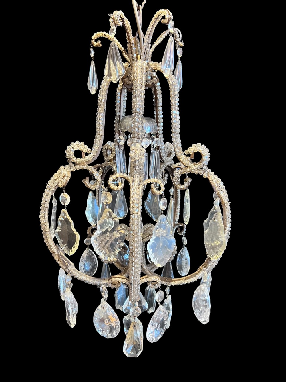 An antique single-light Italian chandelier featuring a metal frame encrusted with clear glass beads and adorned with large faceted crystal drops.