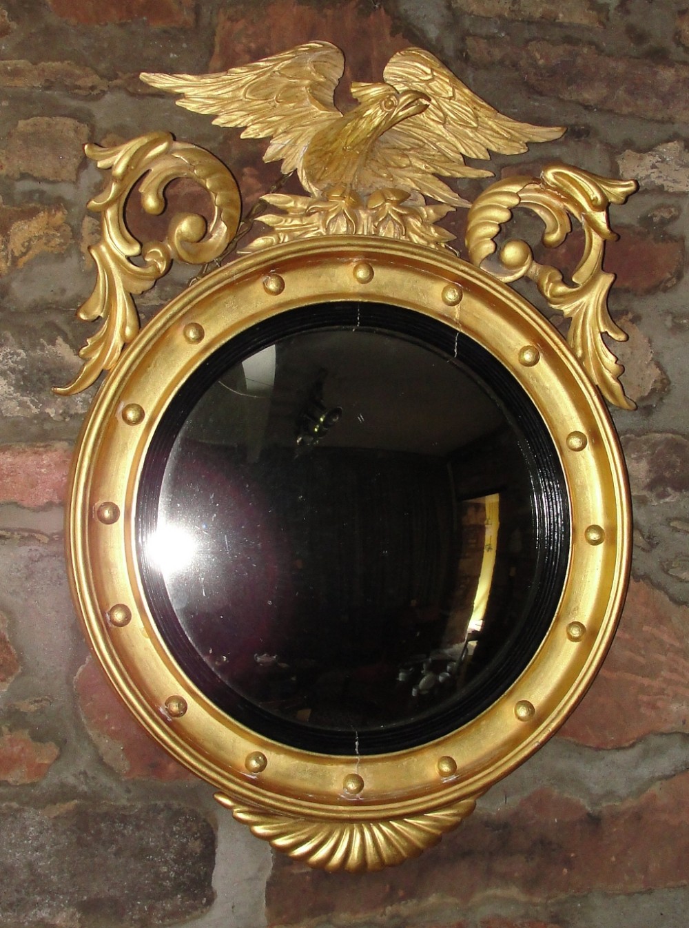 Late Regency gilt convex mirror. Circa 1830