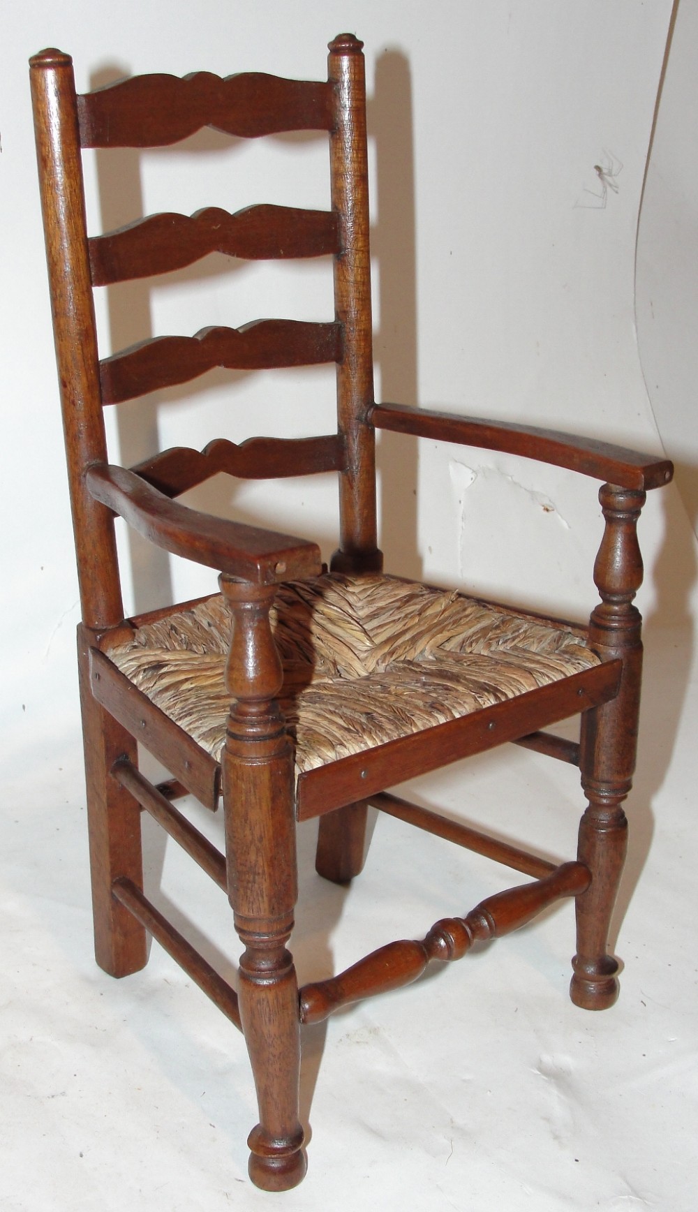 Victorian miniature rush seat elbow chair. Circa 1860