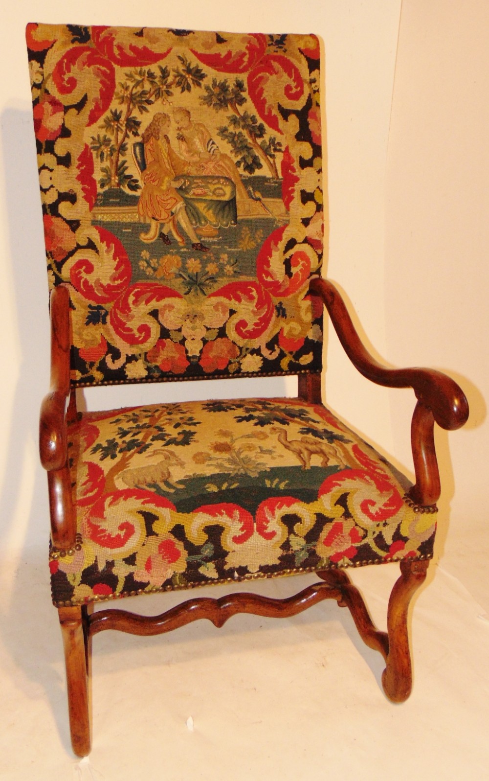 18th century French walnut elbow chair, original upholstery. Circa 1720
