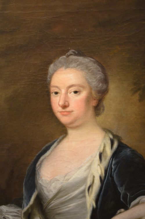 fig 1. An 18th-century oil painting on canvas depicting a seated woman in a light gown with a dark blue mantle, set within a carved giltwood frame.