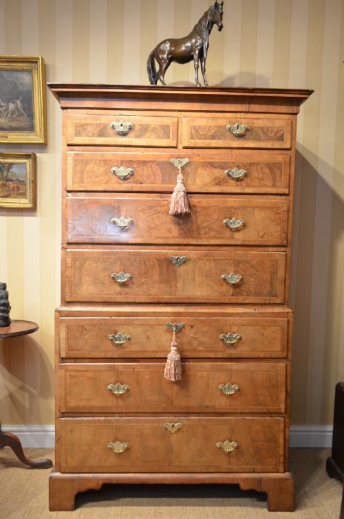 fig 1. A GEORGE II WALNUT AND FEATHER BANDED CHEST ON CHEST