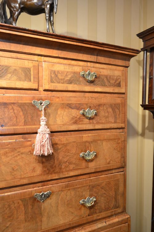 fig 2. A GEORGE II WALNUT AND FEATHER BANDED CHEST ON CHEST