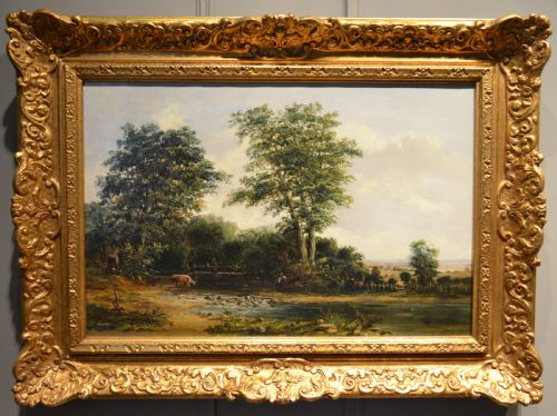 fig 1. A pair of 19th-century oil paintings on canvas depicting peaceful English rural landscapes framed in elaborate gold giltwood frames.