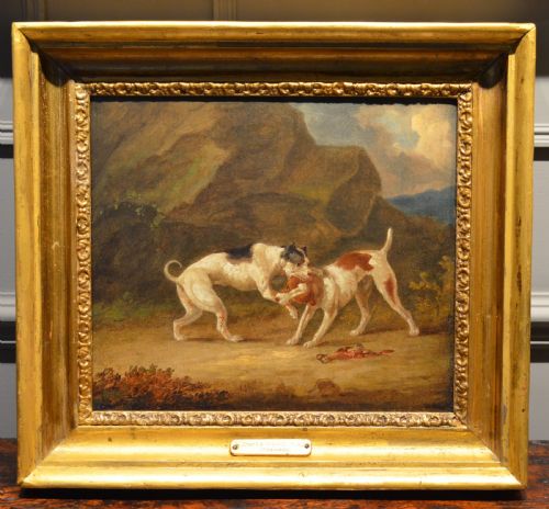 fig 1. An 19th-century oil painting depicting two sporting dogs in an outdoor landscape, enclosed within a heavy carved gilded frame.