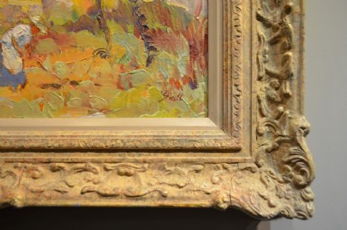 fig 1. An impressionist oil painting on panel depicting figures amidst blossoming trees set inside an ornate carved swept frame.