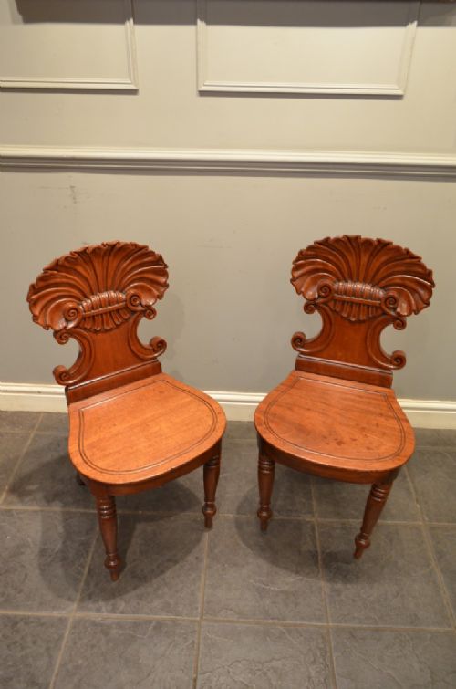 AN EXCEPTIONAL PAIR OF CARVED MAHOGANY SHELL BACK HALL CHAIRS C1815