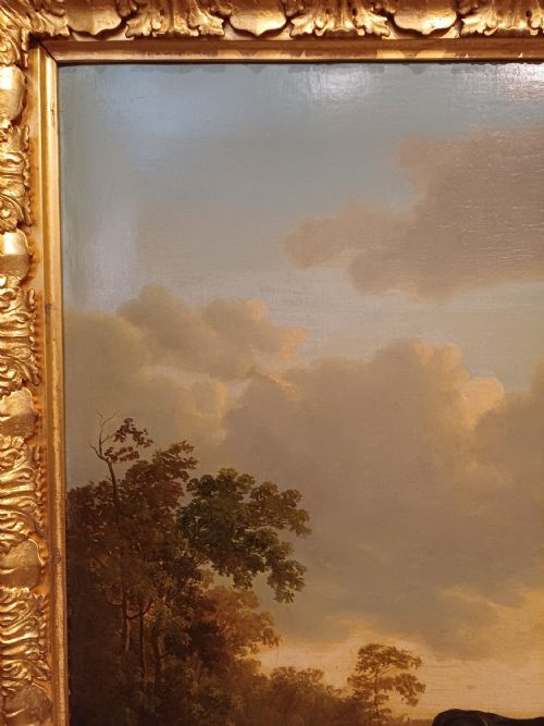 fig 5. A 19th-century oil painting depicting cattle and sheep resting in an open pastoral landscape beneath a cloud-filled sky, enclosed in an ornate gilded frame.