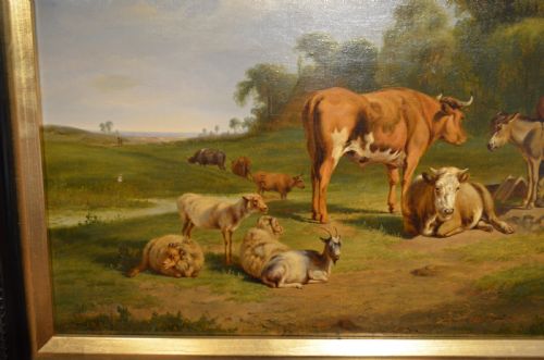 fig 1. An antique framed Dutch pastoral oil painting depicting cattle, sheep, goats, a donkey, and figures in an open landscape under a cloud-filled sky.