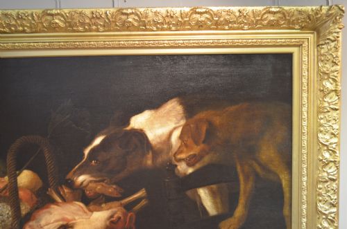 fig 1. An oil painting depicting two dogs reaching into a woven basket containing meat and fruit, encased in an ornate gilded frame.