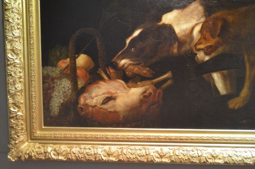 fig 3. An oil painting depicting two dogs reaching into a woven basket containing meat and fruit, encased in an ornate gilded frame.