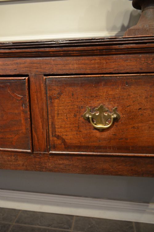 fig 1. A Georgian solid oak dresser base featuring three drawers with brass swan-neck handles, supported by four straight square legs.