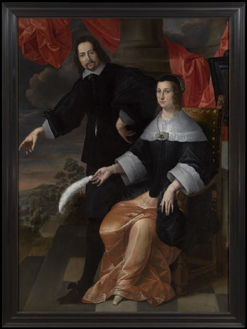 An oil painting depicting a standing man in black attire and a seated woman holding a feather, set against a dark architectural backdrop within a black wooden frame.