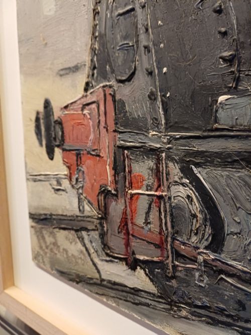 fig 2. An original oil painting on board depicting a dark grey and red side tank steam locomotive sitting on railway tracks, presented in a light wooden frame with a wide mount.