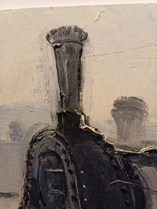 fig 4. An original oil painting on board depicting a dark grey and red side tank steam locomotive sitting on railway tracks, presented in a light wooden frame with a wide mount.
