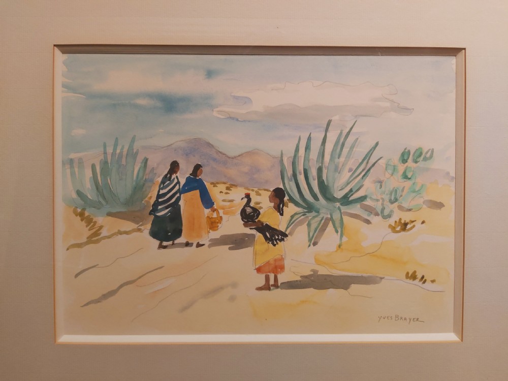 A framed watercolour painting depicting figures walking past agave plants in a desert landscape, presented in a gold-finished wooden frame with a cream mount. View II