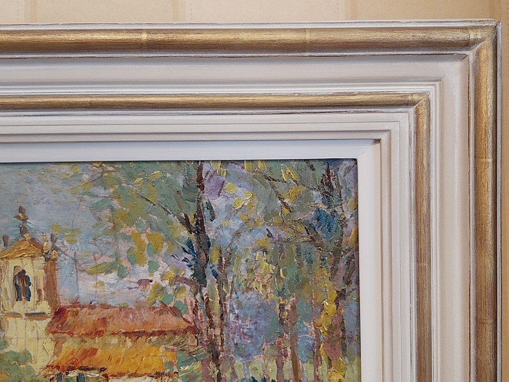 A framed impressionist landscape oil painting depicting a rural church, surrounding village buildings, lavender fields, and a dirt path. View IX