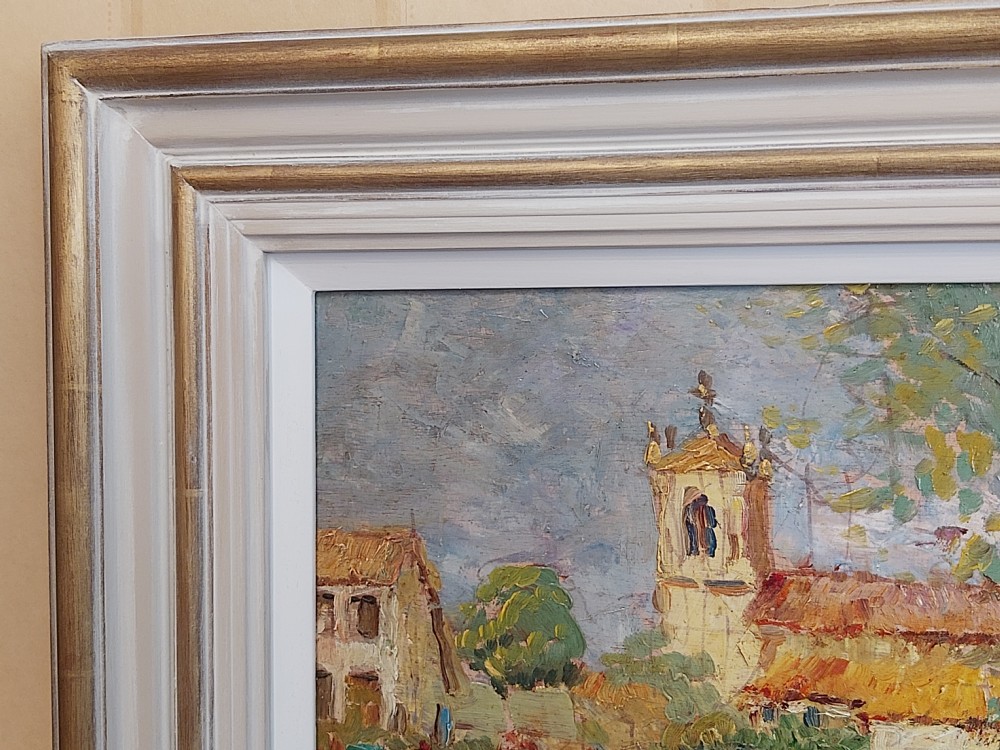 A framed impressionist landscape oil painting depicting a rural church, surrounding village buildings, lavender fields, and a dirt path. View X