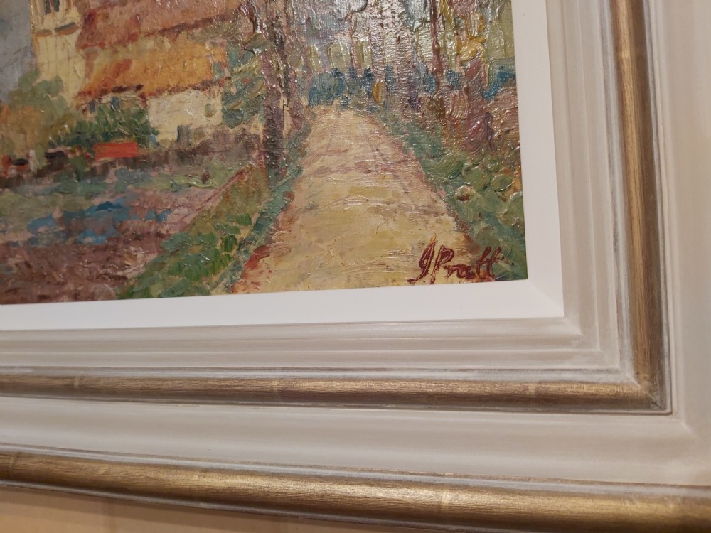 A framed impressionist landscape oil painting depicting a rural church, surrounding village buildings, lavender fields, and a dirt path. View XIII