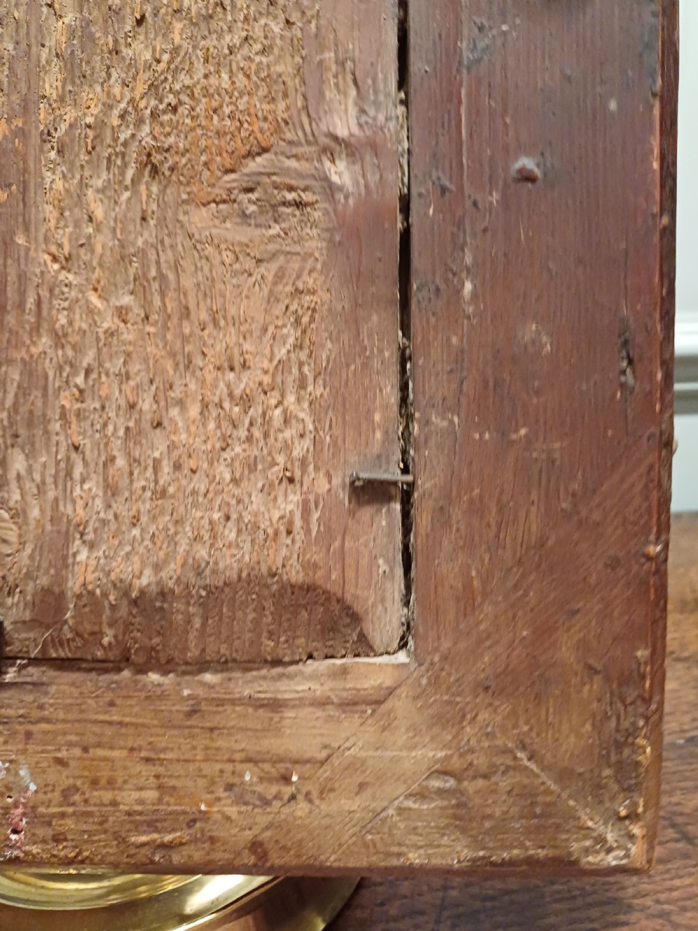 A small rectangular French Regence carved wooden mirror featuring floral motifs and inset glass slips surrounding an aged central mirror plate. View XI