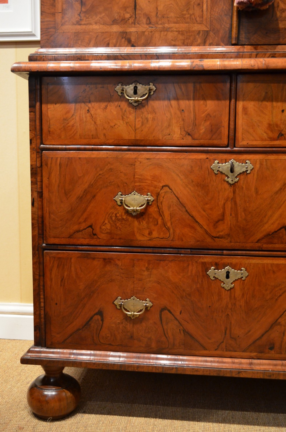 A two-section William and Mary walnut cabinet on chest featuring double doors with burr walnut panel veneers above a lower chest of drawers with turned bun feet. View III