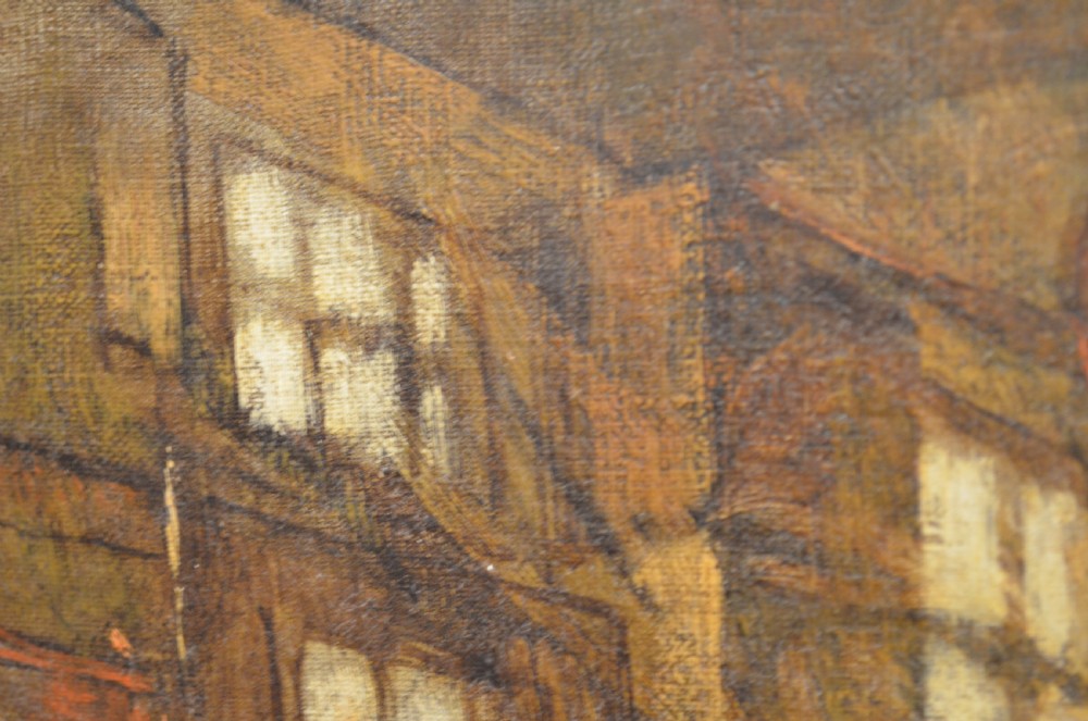 A 19th-century framed oil painting depicting a rustic interior scene with a figure near a table amidst hanging items. View XIII