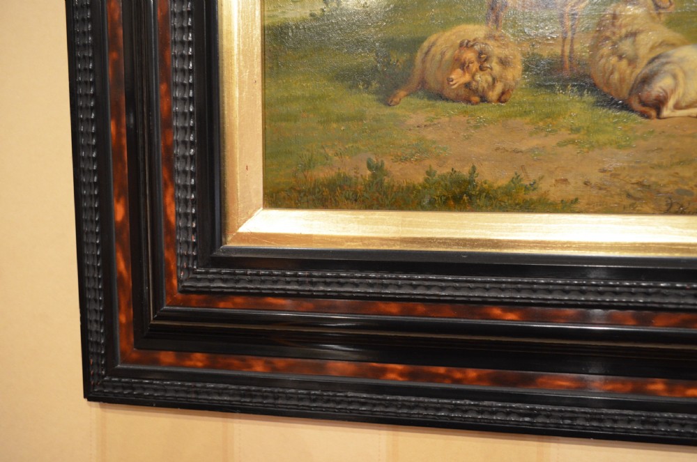 An antique framed Dutch pastoral oil painting depicting cattle, sheep, goats, a donkey, and figures in an open landscape under a cloud-filled sky. View VI