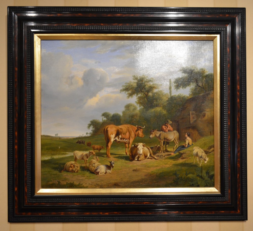 An antique framed Dutch pastoral oil painting depicting cattle, sheep, goats, a donkey, and figures in an open landscape under a cloud-filled sky. View VII