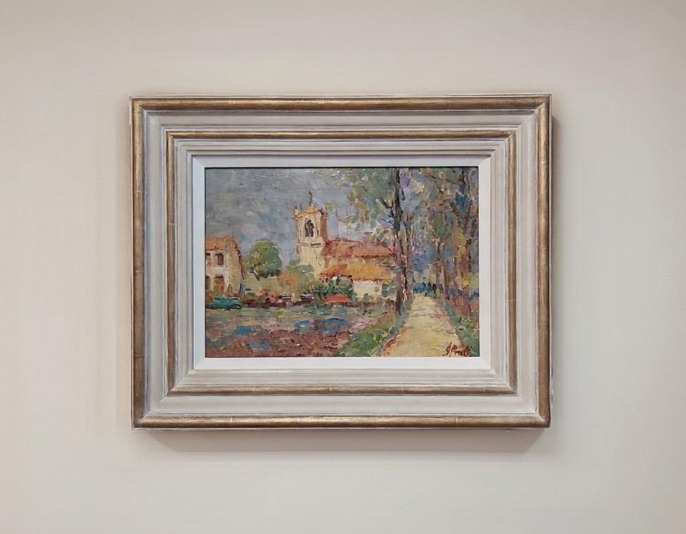 A framed impressionist landscape oil painting depicting a rural church, surrounding village buildings, lavender fields, and a dirt path.