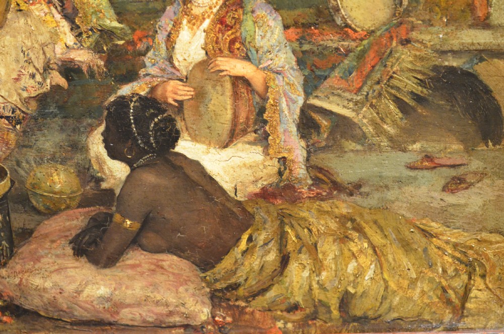 A framed 19th-century Orientalist oil painting on board featuring figures playing music and resting in a detailed interior scene. View II