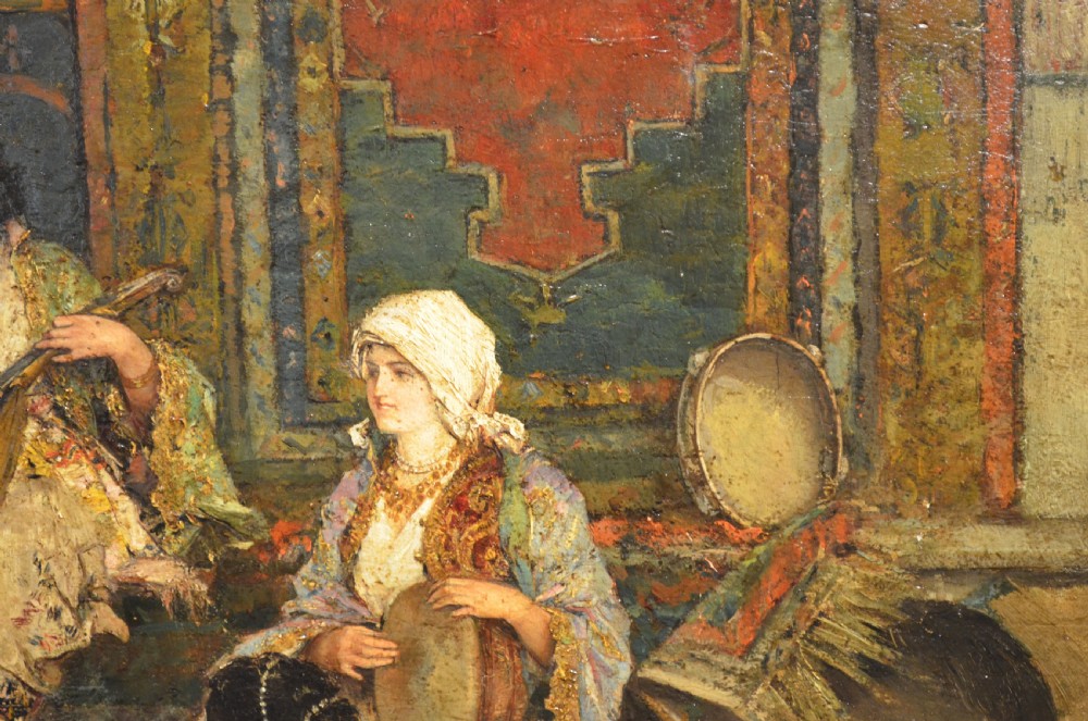 A framed 19th-century Orientalist oil painting on board featuring figures playing music and resting in a detailed interior scene. View III