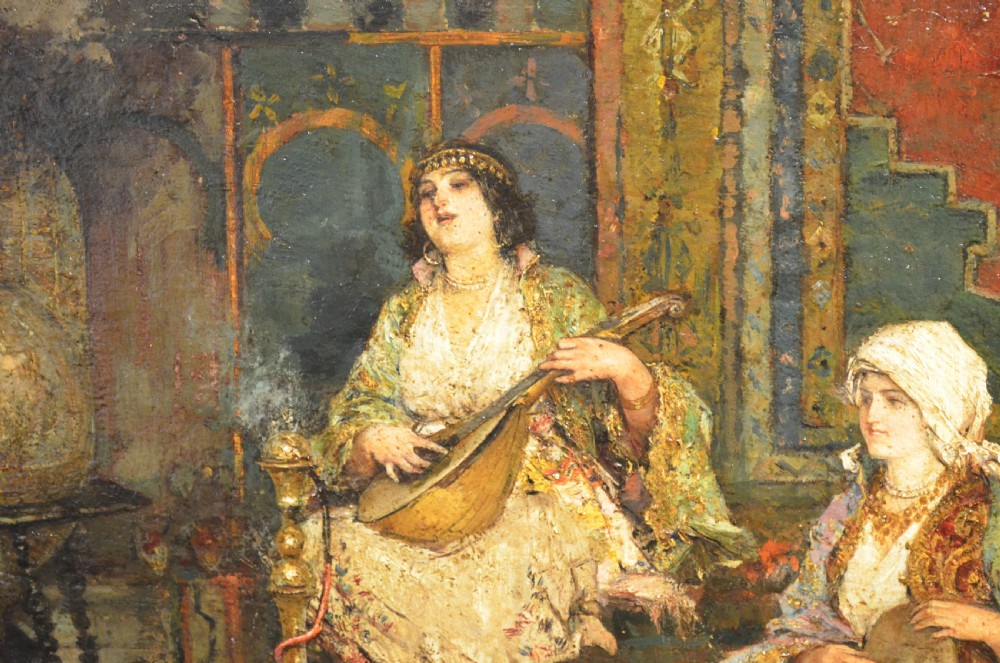 A framed 19th-century Orientalist oil painting on board featuring figures playing music and resting in a detailed interior scene. View VI