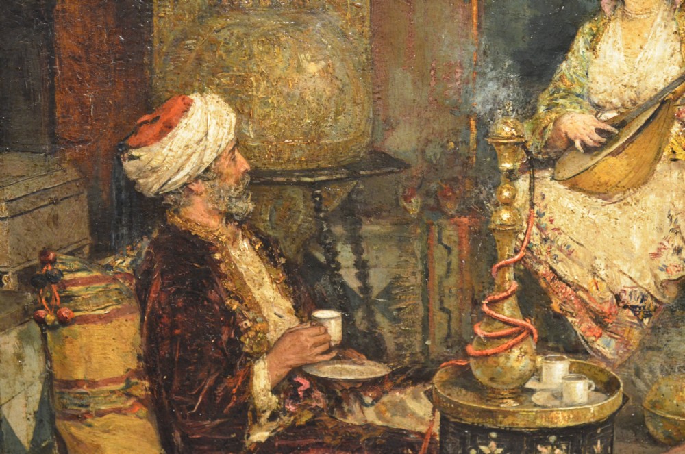 A framed 19th-century Orientalist oil painting on board featuring figures playing music and resting in a detailed interior scene. View VII