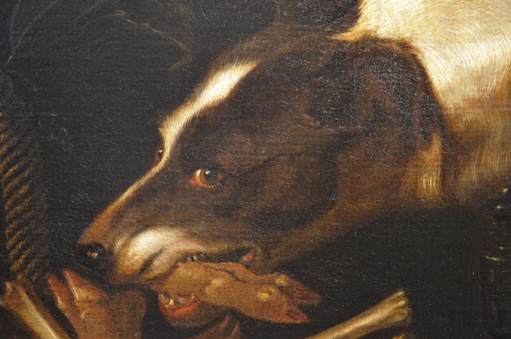 An oil painting depicting two dogs reaching into a woven basket containing meat and fruit, encased in an ornate gilded frame. View IX