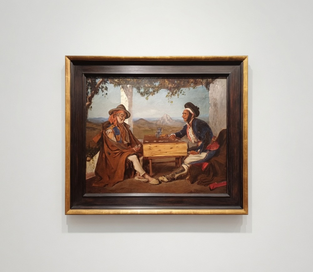 A framed 19th-century oil painting on canvas depicting two men in traditional Spanish attire playing cards at a wooden table beneath a vine-covered trellis.