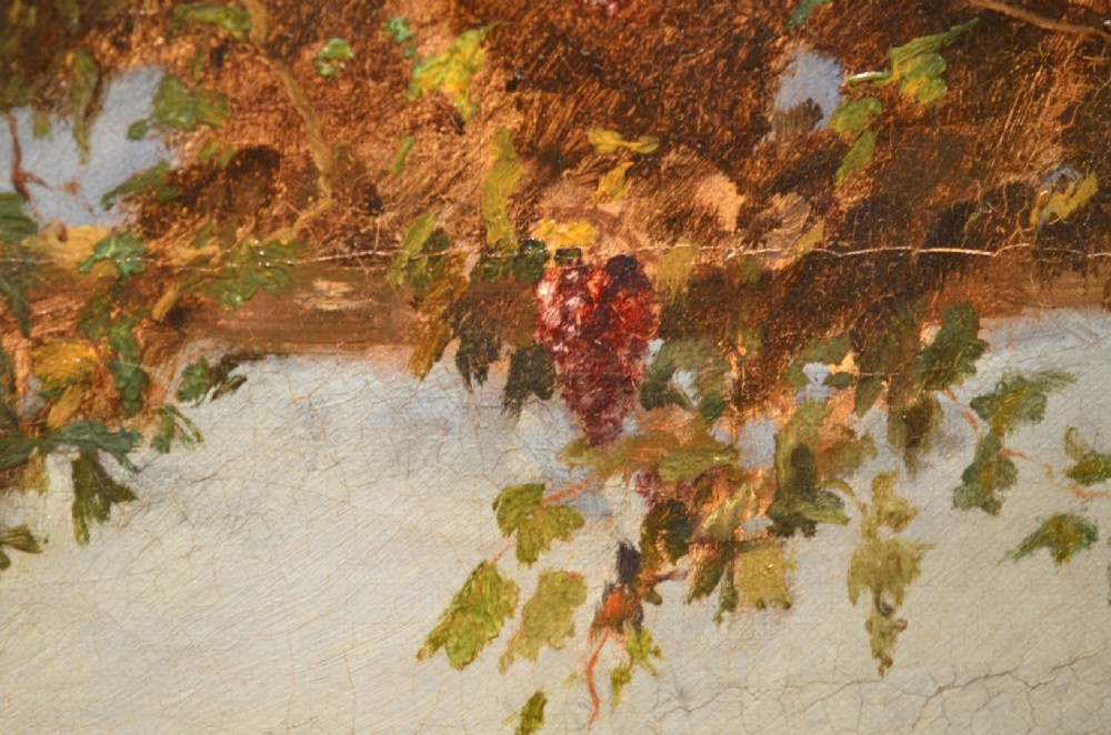 A framed 19th-century oil painting on canvas depicting two men in traditional Spanish attire playing cards at a wooden table beneath a vine-covered trellis. View XIII